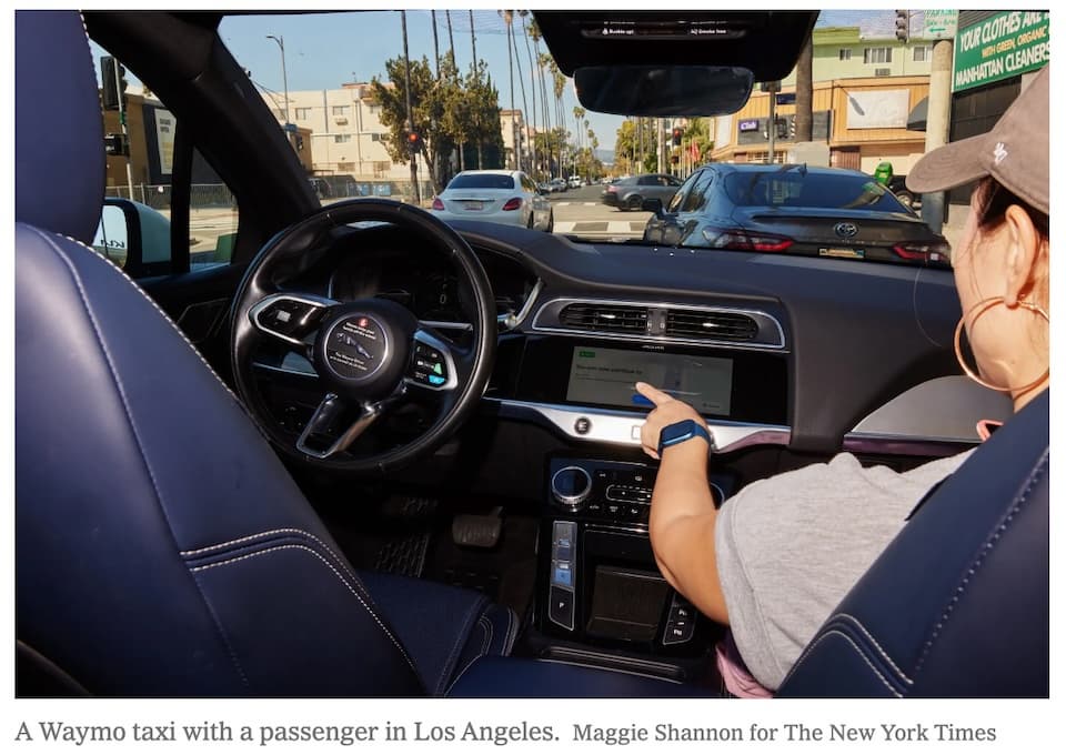 A Waymo taxi with a passenger in Los Angeles